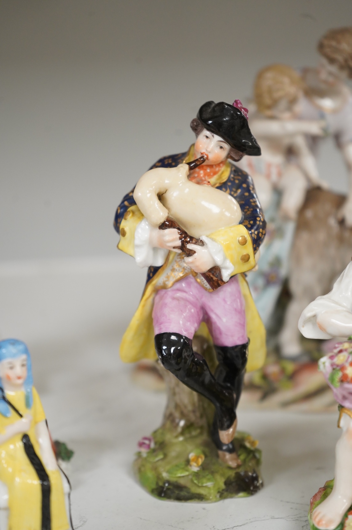Two Derby porcelain seated figures emblematic of summer and autumn and a collection of Continental porcelain figures to include a pair of recumbent cows, largest 18cm high